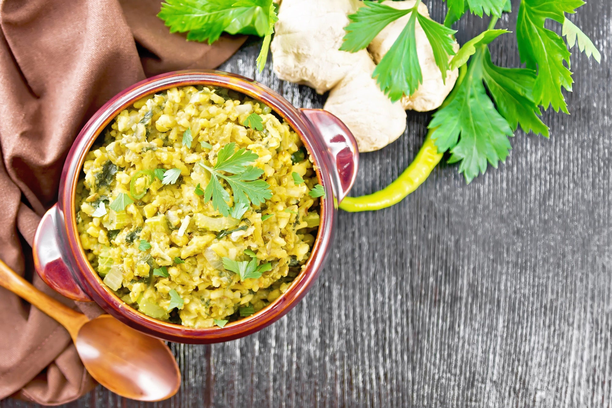 bowl of ayurvedic kitchari a lentil rice dish with ginger and coriander in background 