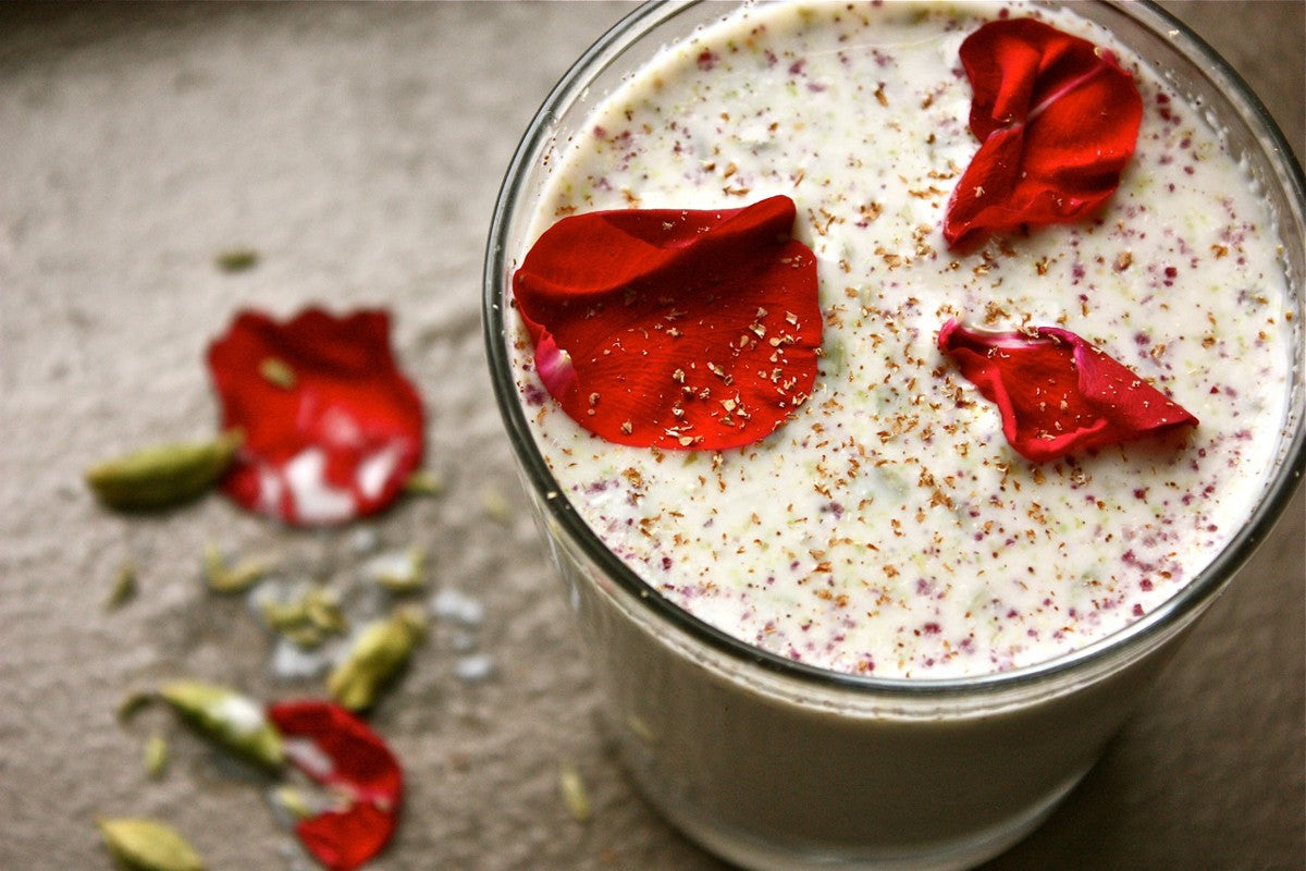 Ayurvedic summer drink topped with bright red rose petals