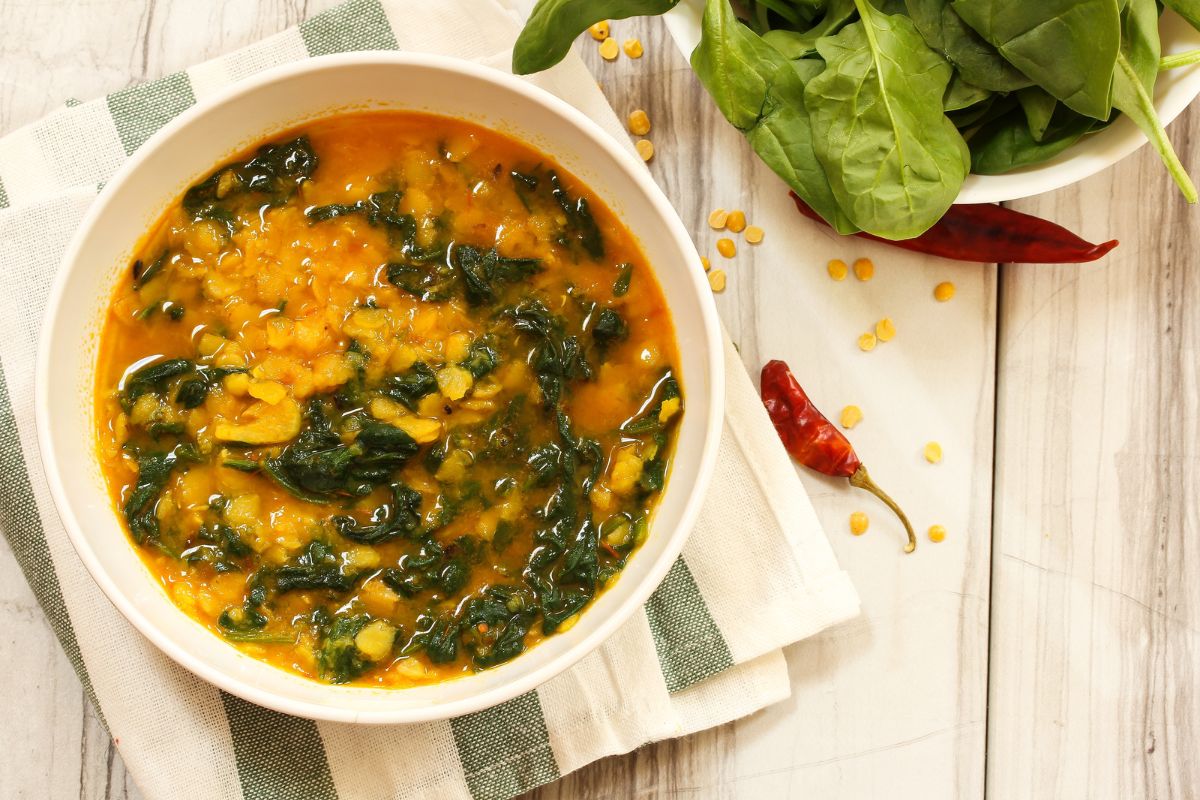 delicious lentil and spinach soup in a bowl on a kitchen bench