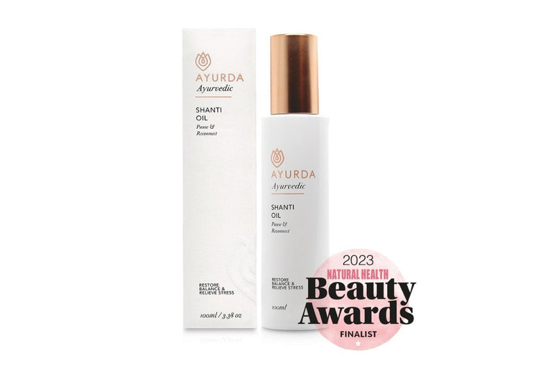 Ayurda shanti oil next to packaged box with 2023 Natural Beauty Awards finalist award logo